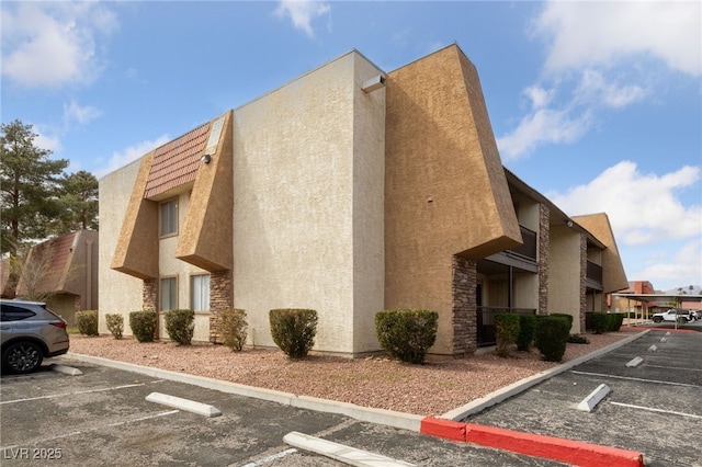 view of property featuring uncovered parking