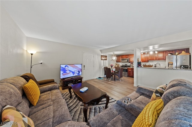 living room with light wood-type flooring and baseboards