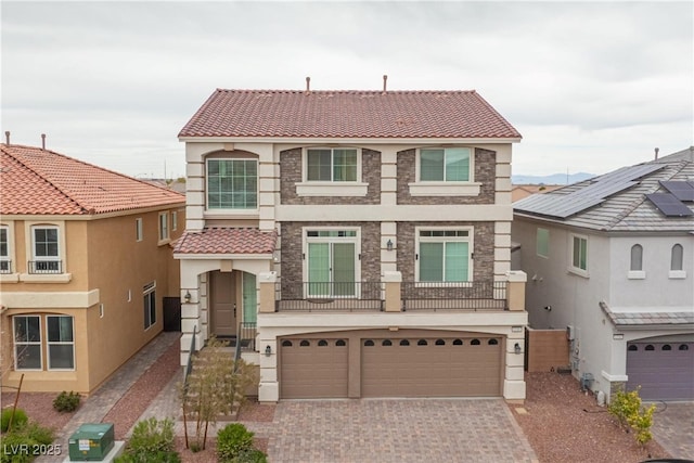 6346 Rock Strm Ln, Las Vegas, NV 89141 - mediterranean / spanish-style house with driveway, a tiled roof, a garage, stucco siding, and stone siding