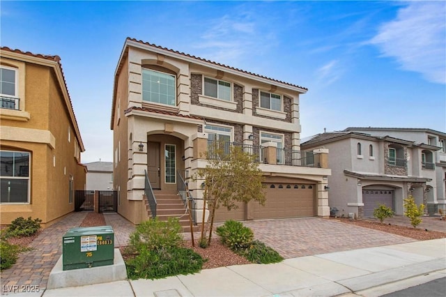 view of front of home with entry steps, stucco siding, a garage, driveway, and a gate