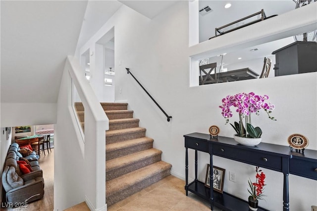 staircase featuring tile patterned flooring and visible vents