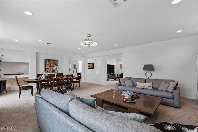 living area with recessed lighting, visible vents, baseboards, and carpet