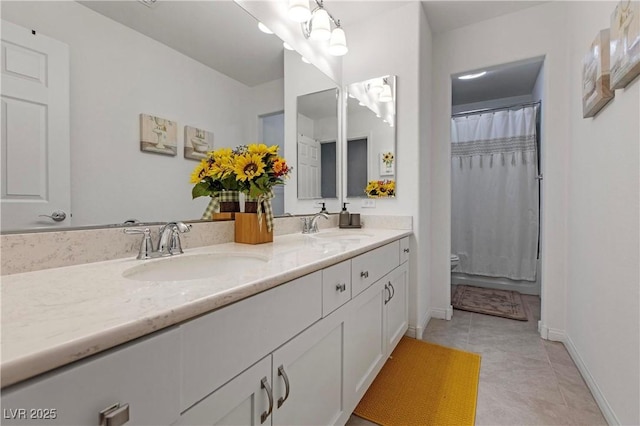 full bath with double vanity, tile patterned floors, toilet, and a sink