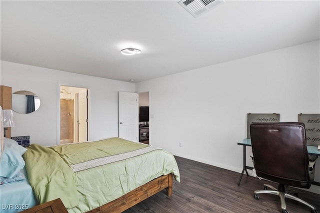 bedroom featuring visible vents, baseboards, and wood finished floors