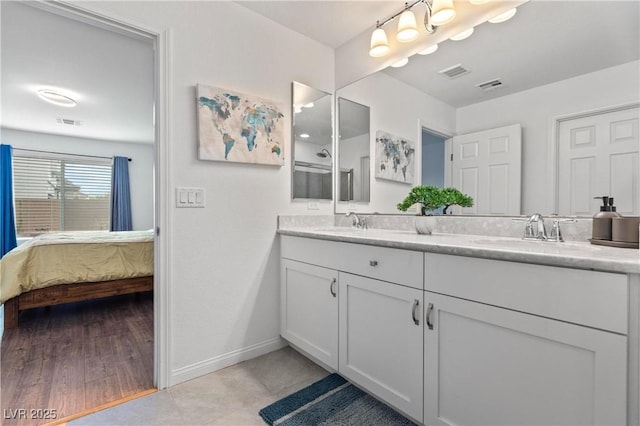 full bath with connected bathroom, visible vents, and a sink