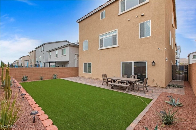 6346 Rock Strm Ln, Las Vegas, NV 89141 - rear view of house with a patio, a residential view, stucco siding, a fenced backyard, and a yard
