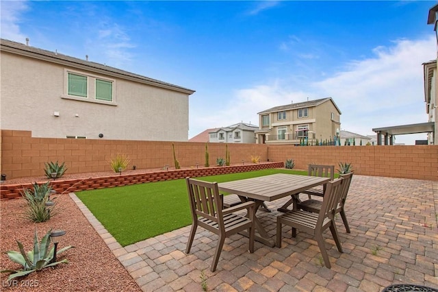 view of patio with outdoor dining area and a fenced backyard