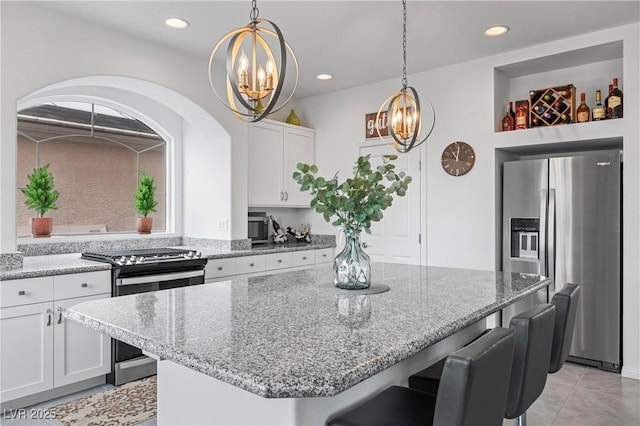 6346 Rock Strm Ln, Las Vegas, NV 89141 - kitchen with an inviting chandelier, a kitchen breakfast bar, a center island, and appliances with stainless steel finishes