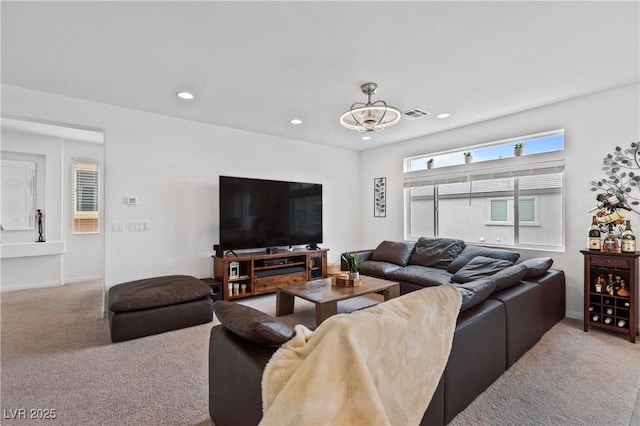 carpeted living room with recessed lighting and visible vents