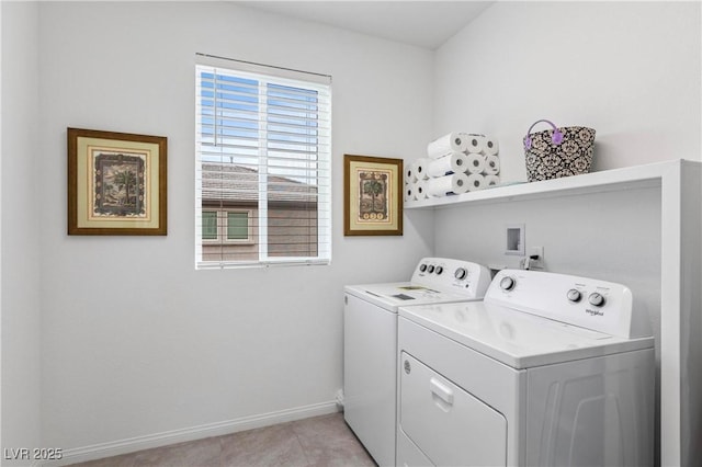 washroom featuring laundry area, light tile patterned floors, washing machine and dryer, and baseboards