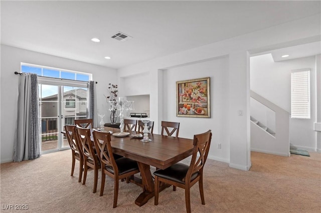 dining space with visible vents, baseboards, light colored carpet, stairs, and recessed lighting