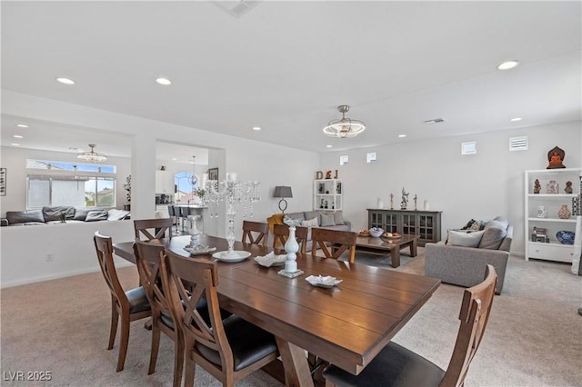 dining space with recessed lighting, visible vents, light carpet, and an inviting chandelier