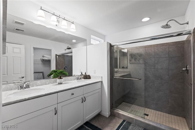 6346 Rock Strm Ln, Las Vegas, NV 89141 - full bathroom with a stall shower, visible vents, a sink, and double vanity