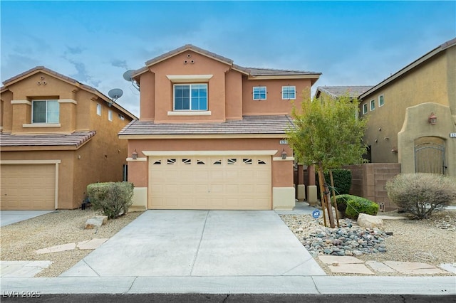 view of front of home featuring concrete driveway, a tiled roof, a garage, and stucco siding