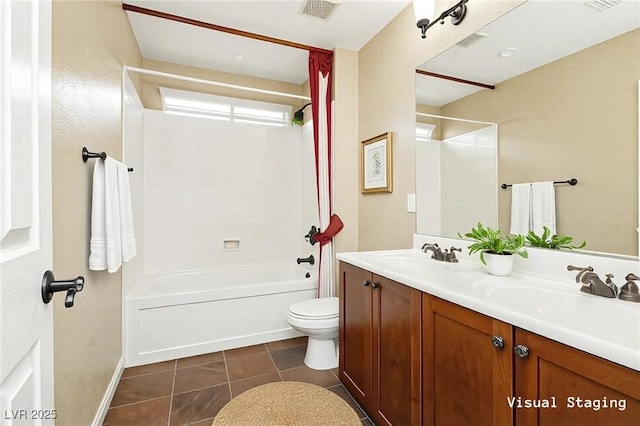 bathroom with tile patterned floors, toilet, shower / bathing tub combination, and a sink