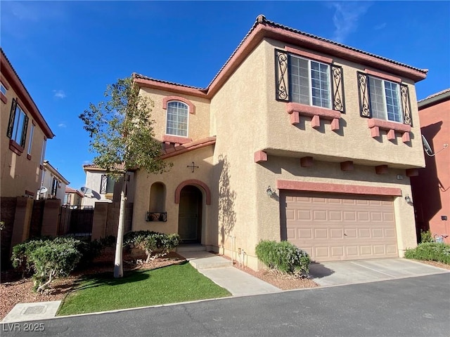 mediterranean / spanish-style house with a tiled roof, stucco siding, driveway, and a garage