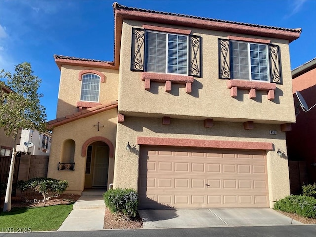 mediterranean / spanish house with a tiled roof, stucco siding, driveway, and a garage