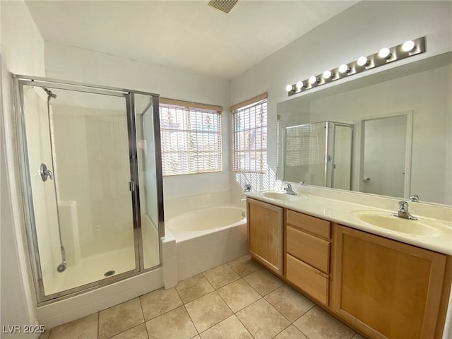 bathroom with a sink, a garden tub, a stall shower, and tile patterned floors