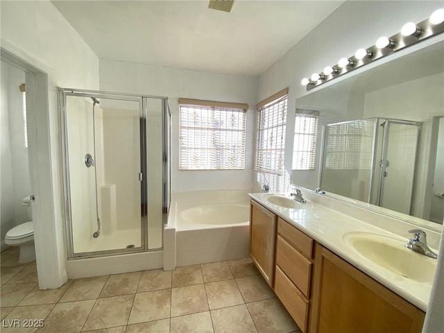 full bathroom with tile patterned floors, toilet, a shower stall, and a sink