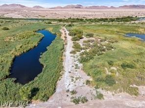 drone / aerial view with a water and mountain view