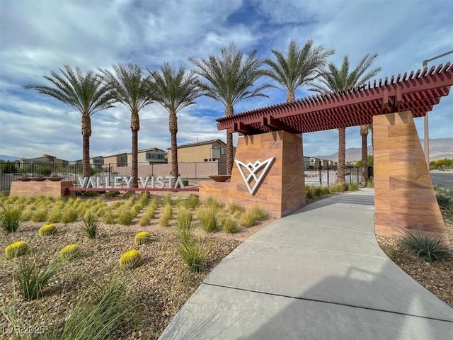 view of home's community with fence and a pergola