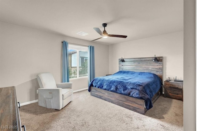 carpeted bedroom with visible vents, baseboards, and a ceiling fan