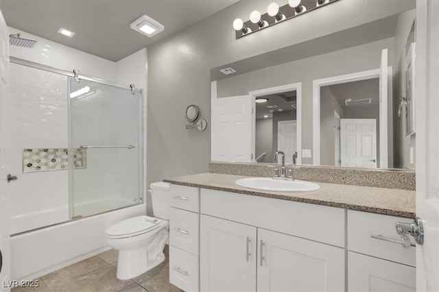 bathroom with vanity, toilet, shower / bath combination with glass door, and tile patterned flooring