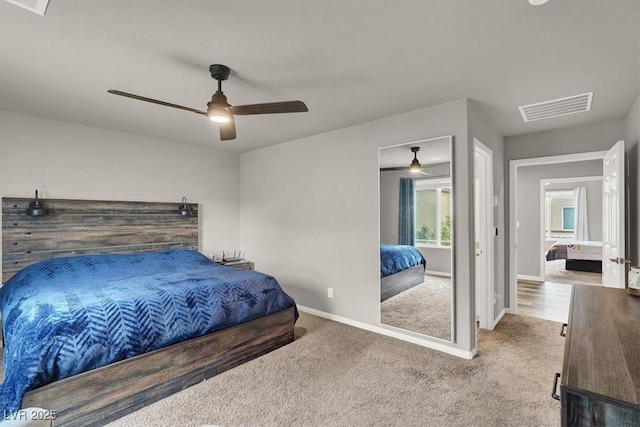 carpeted bedroom with visible vents, ceiling fan, and baseboards