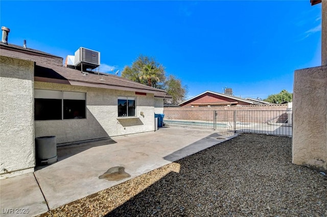 view of yard featuring a patio area, a fenced in pool, cooling unit, and a fenced backyard