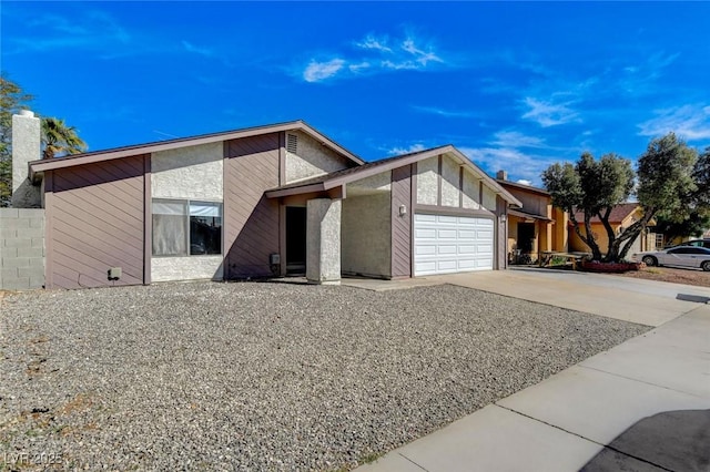 view of front of home with driveway and a garage