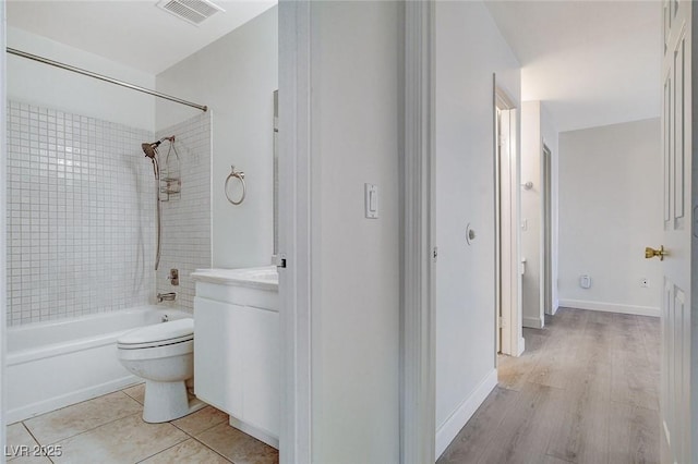 bathroom with vanity, visible vents, bathing tub / shower combination, toilet, and tile patterned floors