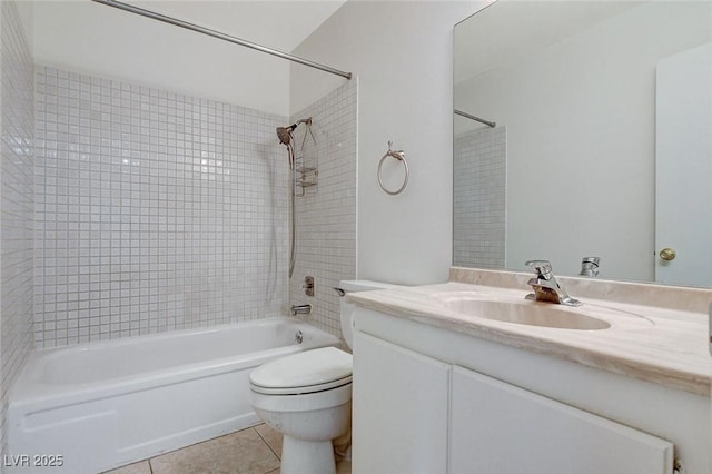 bathroom with tile patterned floors, toilet, tub / shower combination, and vanity