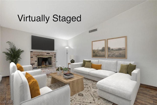 living room featuring visible vents, lofted ceiling, wood finished floors, and a fireplace