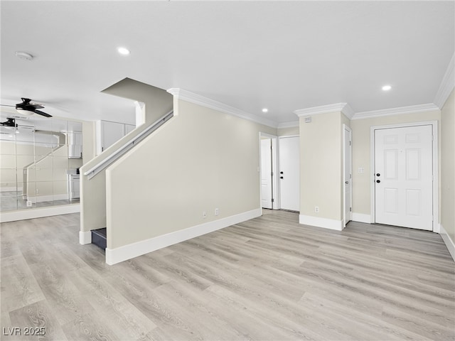 unfurnished living room with light wood finished floors, baseboards, a ceiling fan, and ornamental molding