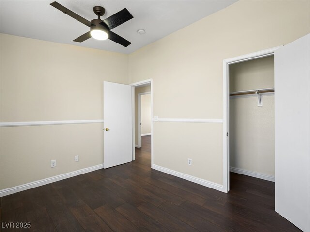 unfurnished bedroom featuring a closet, dark wood-style flooring, baseboards, and ceiling fan