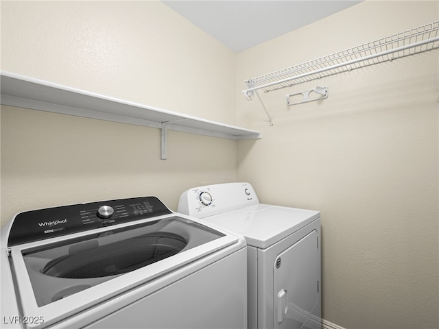laundry room featuring separate washer and dryer and laundry area