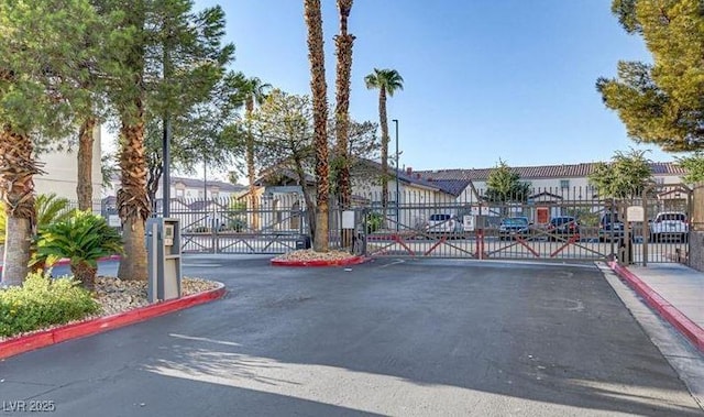 view of street with a gated entry, a residential view, and a gate