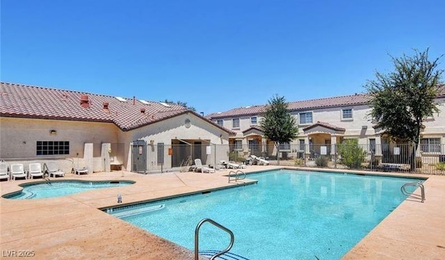 pool featuring fence and a patio