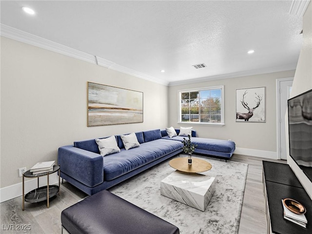 living area featuring visible vents, baseboards, crown molding, recessed lighting, and wood finished floors