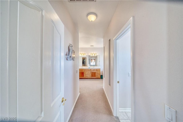 corridor with carpet flooring and baseboards