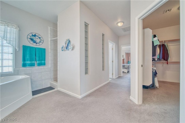 corridor featuring carpet flooring and visible vents