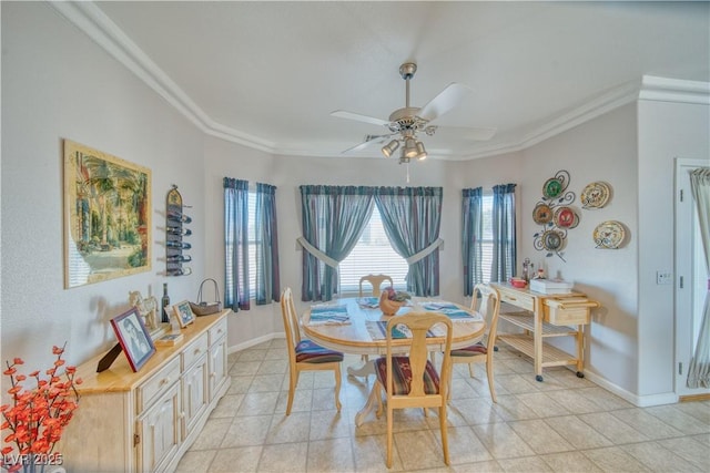 dining room with light tile patterned floors, baseboards, crown molding, and a ceiling fan