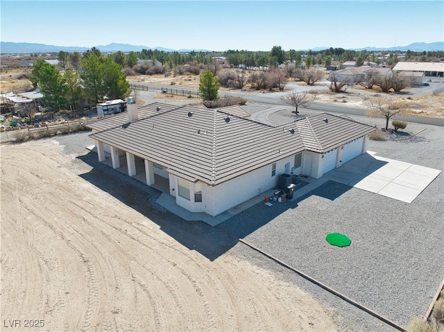 birds eye view of property featuring a mountain view