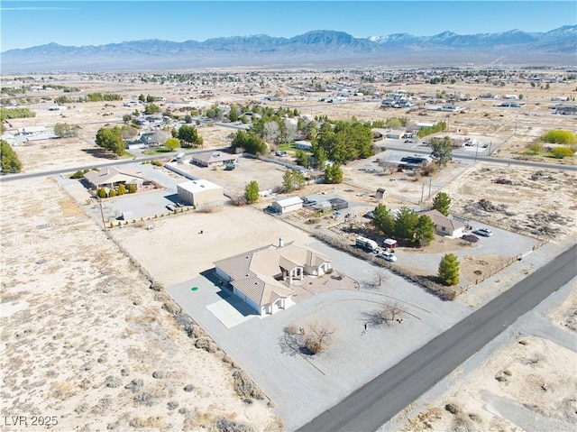 birds eye view of property featuring view of desert and a mountain view