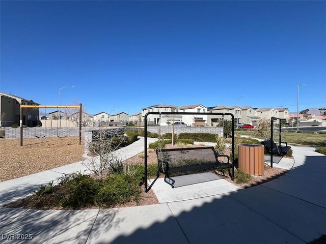 surrounding community with a residential view, playground community, and fence