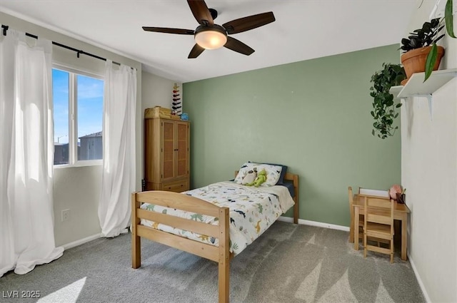 carpeted bedroom featuring baseboards and ceiling fan