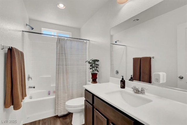 bathroom featuring visible vents, toilet, shower / bath combo with shower curtain, wood finished floors, and vanity