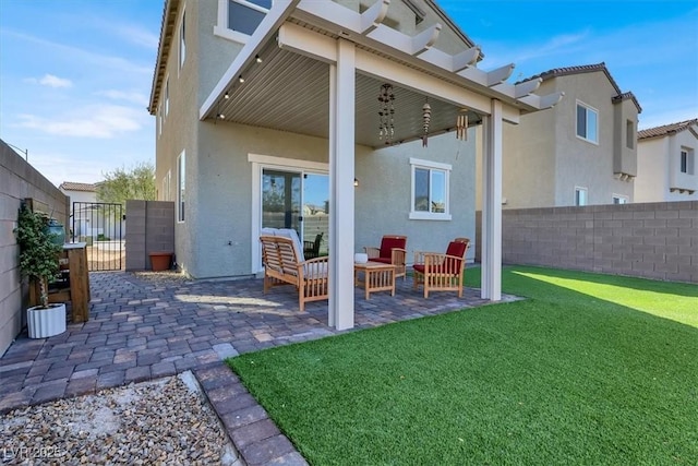 rear view of property featuring a patio, a yard, fence private yard, and stucco siding