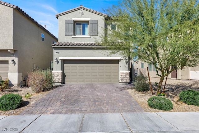 view of front of property featuring an attached garage, stucco siding, stone siding, a tiled roof, and decorative driveway