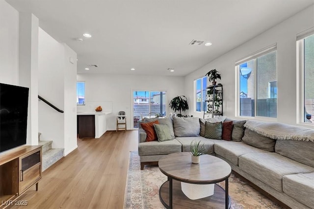 living area with visible vents, recessed lighting, stairway, and light wood-style floors